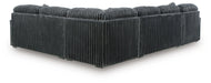 Dark gray corduroy-textured sectional sofa, viewed from the back and side, showing its L-shape and ribbed fabric.