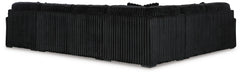 Black L-shaped sectional sofa, viewed from the back and side, featuring a plush ribbed corduroy-like upholstery.