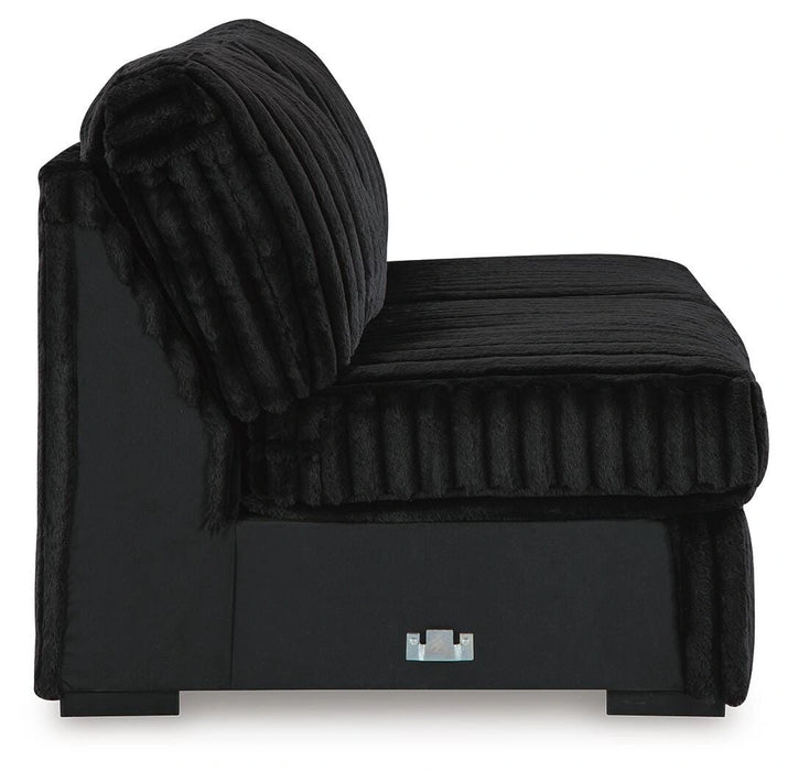 Black armless modular sofa section with plush, ribbed fabric cushions and a smooth fabric base. The back and seat cushions feature a corduroy-like texture, and the unit sits on low, square feet.