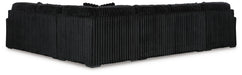 Black L-shaped sectional sofa with a distinctive vertical ribbed corduroy-like fabric texture, shown from the back and side.