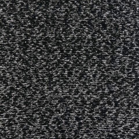 Close-up of a black and white speckled fabric with a textured, mottled appearance.