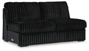 Black modular armless chair upholstered in plush ribbed velvet fabric, featuring channel-tufted back and seat cushions and low dark feet.