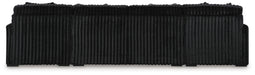 Black upholstered headboard with a plush, vertically ribbed texture and a rounded, segmented top edge.