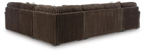 Brown sectional sofa, back and side view, featuring a plush corduroy-like ribbed fabric texture and low, dark feet.